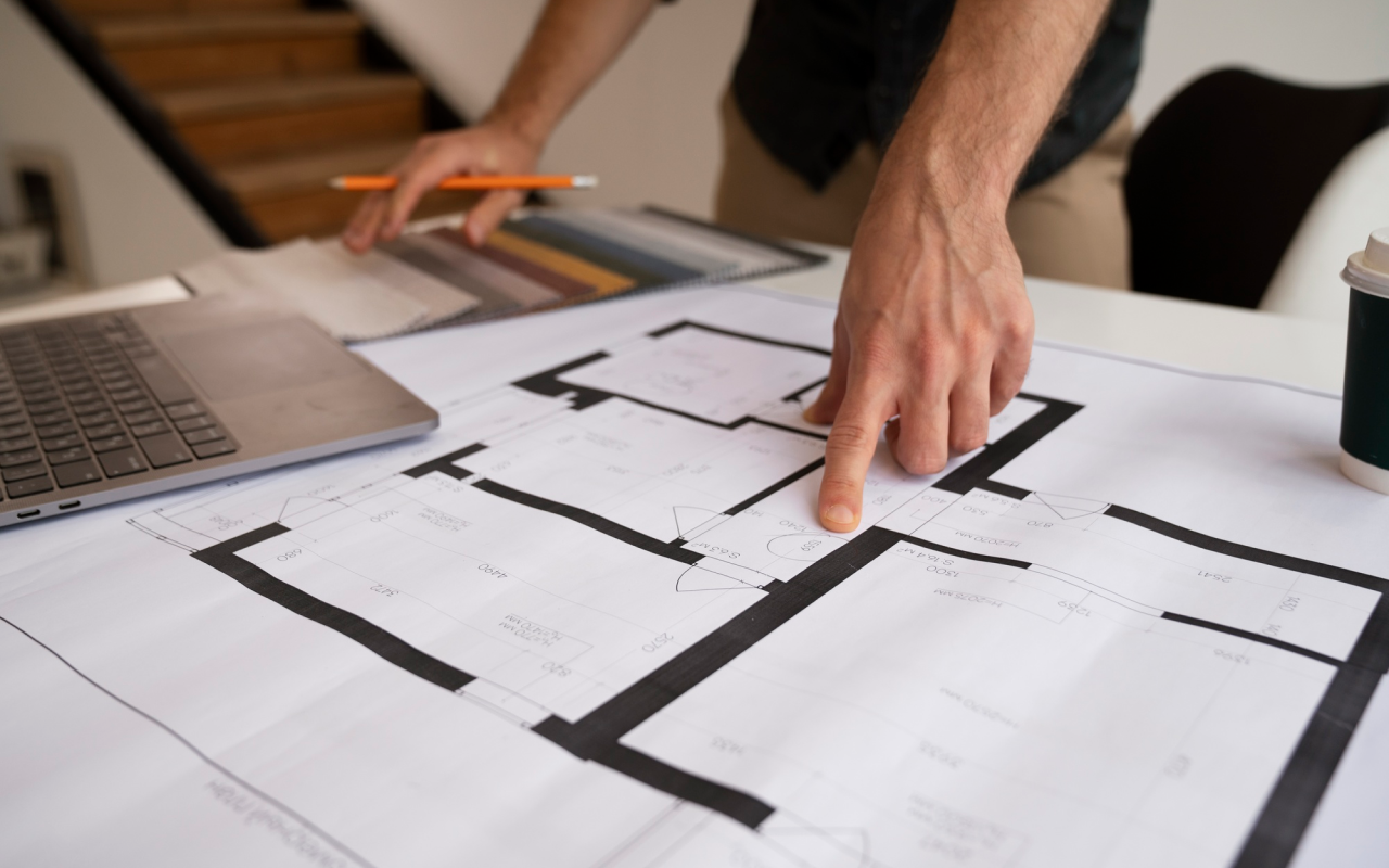 Hand pointing architectural plans
